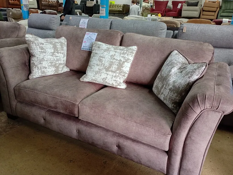Dusky pink fabric 3 seater sofa with scatter cushions and deep button detailing on the arms