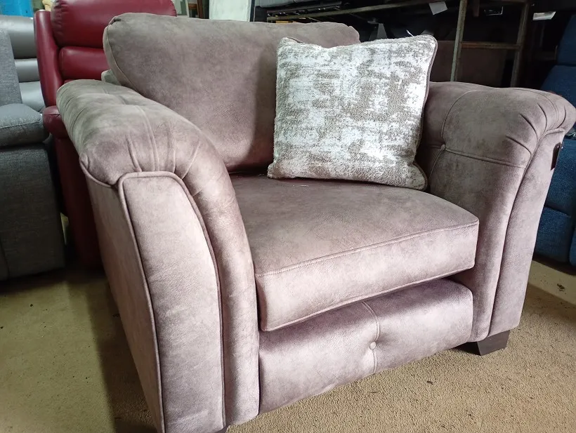 Dusky pink textured fabric armchair with scatter cushion and button-tufted arms and seat front