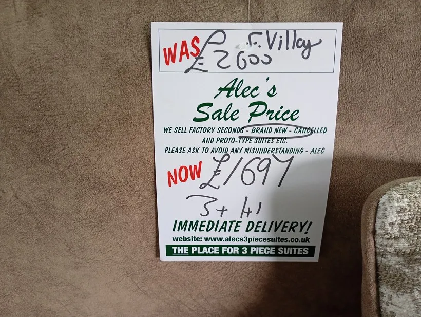 Handwritten sale price ticket for ex-display clearance sofas