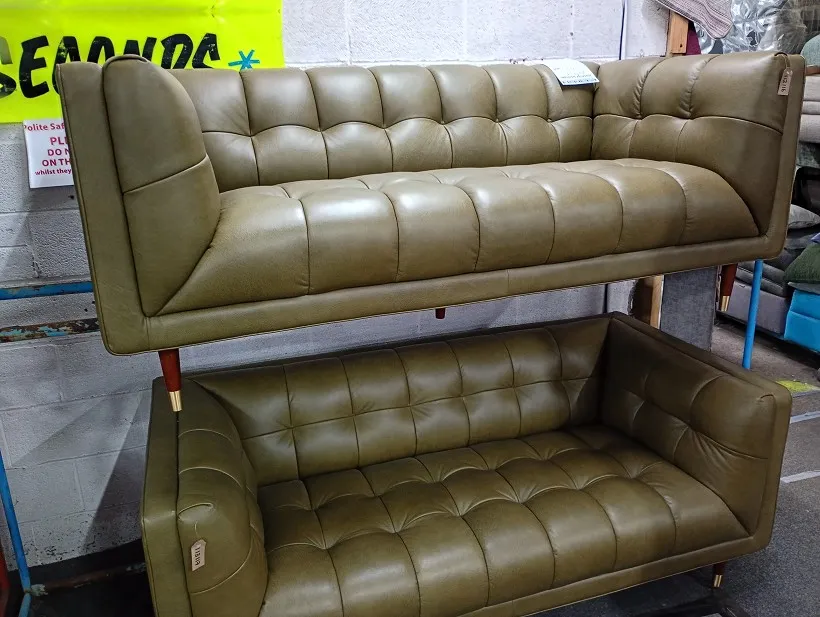 Olive green leather buttoned sofa with wooden legs, stacked above a matching second sofa