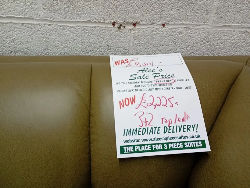 Handwritten sale price ticket for ex-display clearance sofas