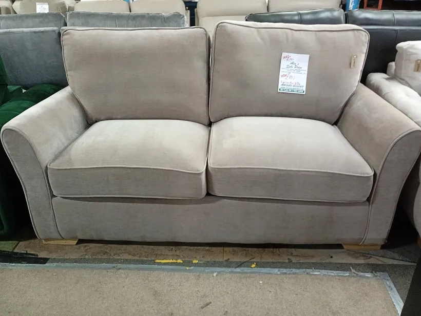 Beige fabric 2 seater sofa with loose pillow back cushions and textured weave upholstery